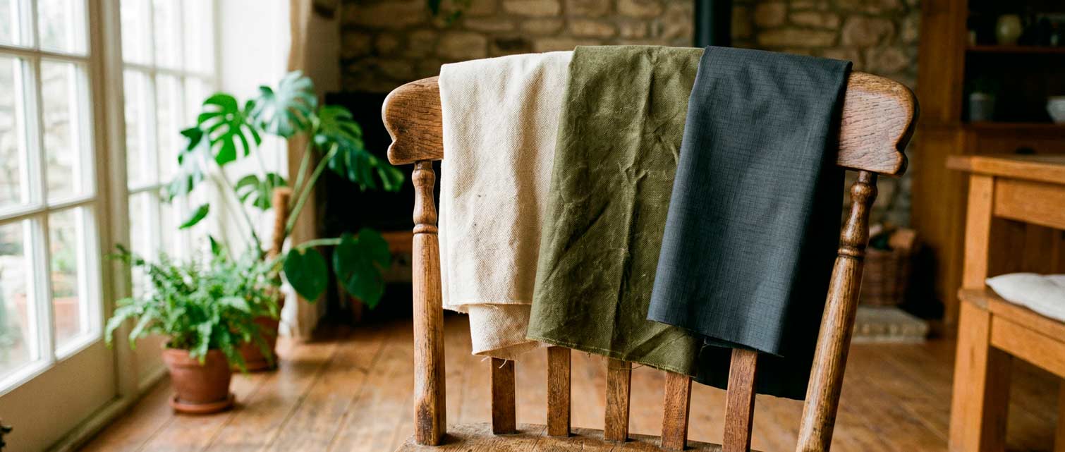 three bag fabric samples draped over wooden chair